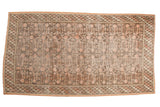 Vintage distressed Khotan carpet, allover pomegranate motif, braided border, muted pink, brown, ivory. 6' x 11'.