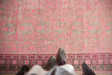 Vintage distressed Khotan runner with vibrant pink pomegranate motifs and geometric border.