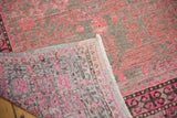 Distressed Khotan rug corner with worn pink patterns, faint foundation, and hand knotted reverse.