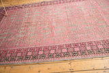 Distressed Khotan rug section, with fuchsia pink, oxidized silver, and geometric charcoal border.