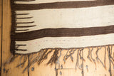 Hand-woven Turkish Kilim showing chocolate brown and ivory stripes, comb effect, and fringe.