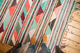 Hand-woven vintage Turkish rag rug with playful stripes, vibrant aqua, red, and ivory triangles.