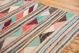 Colorful woven fringe and playful striped pattern on a vintage Turkish rag rug.