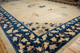 Antique Peking carpet corner, showing unique cobalt blue bat motif border and ivory lattice field.