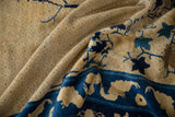 Intricate lattice and blue scrolling floral details on the aged beige pile of an antique Peking carpet.