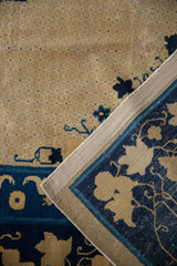 Antique Peking carpet detail: worn beige field, blue lattice, navy floral border, secured side.