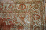 Distressed vintage Veece carpet corner with faded brick red patterns, low pile, and foundation details.