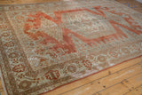 Distressed Veece carpet border with faded brick red, seafoam green motifs, and visible low pile.