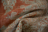 Faded red-orange, seafoam green, and visible foundation on distressed low pile Veece carpet.