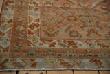 Intricate herati motifs on distressed Malayer rug corner, with faded blush rose and seafoam green.
