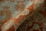 The soft, distressed texture of a vintage Veece carpet's low pile in rust and powder blue.