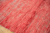 Textured faded cherry red long pile with visible upcycled rag fiber foundation.