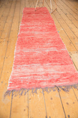 Vintage Moroccan runner in faded cherry red with dynamic texture and shade variations.