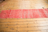 Vintage Moroccan runner with long, faded cherry red pile and textural recesses.
