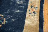 Worn indigo blue field with beige border, featuring delicate blue and blush floral vinery.