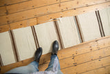 Ivory and brown striped hand woven Turkish Kilim runner with visible frayed edge.