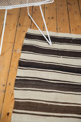 Vintage Turkish Kilim rug, showing rhythmic horizontal stripes in varied brown and ivory tones.