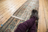 Fragmented antique Lilihan rug runner showing distressed pale beige field, faded blue, wine red floral pattern.