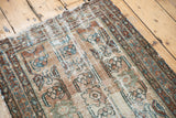 Visible hard wear on antique Lilihan runner, with faded floral palmettes in pale beige and blue.