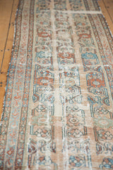 Distressed floral vinery and worn foundation of an antique Lilihan runner.