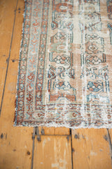 Antique fragmented Lilihan runner detail showing hard wear, faded vinery, and tattered edge.