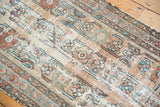 Distressed antique Lilihan runner showcasing faded floral vinery, hard wear, and soft patina.