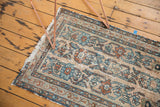 Distressed Lilihan runner with worn pile, exposed foundation, faded blue, red floral vinery.