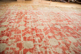 Antique Distressed Khotan carpet with faded cinnabar pomegranate motif, abrashes, and knot wear.