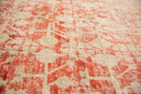 Distressed Khotan carpet texture, faded cinnabar red and ivory with worn pomegranate motifs.
