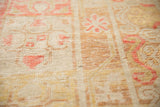 Antique distressed Khotan pile texture, faded cinnabar red, ivory, and mostly even wear.