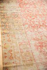 Antique Khotan carpet's distressed pile texture, revealing faded cinnabar and ivory abrashes.
