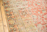 Distressed antique Khotan rug showing mostly even wear to faded cinnabar, ivory pile, and border.