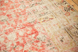 Faded cinnabar red, ivory, and gold tones on antique Khotan rug with dynamic abrashes.