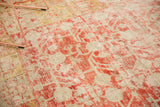 Distressed antique Khotan carpet detail, faded cinnabar red stemmed pomegranate motifs, mostly even wear.