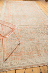 Distressed antique Khotan runner showing even pile wear with foundation, terra cotta blush pomegranate motifs.