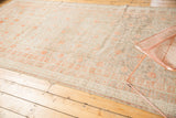 Antique distressed Khotan rug surface, showing soft platinum and terra cotta blush tones.