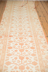 Distressed Khotan runner pile with faded cherry red stemmed pomegranate motifs and wear.