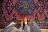 Vintage Veece rug's central medallion, geometric black cherry red and cobalt blue pattern.