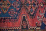 Hand-knotted geometric patterns of a vintage Persian Veece rug in red and navy blue.