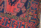 Hand-knotted Veece rug corner with black cherry red, navy blue geometric motifs and fringe.