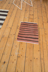Secured fringed end and horizontal banded stripes of the vintage Turkish Kilim rug mat.