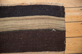 Close-up of hand woven Turkish Kilim with charcoal brown and nuanced neutral bands.