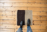 Contrasting charcoal and beige color blocks on a hand woven Turkish Kilim rug.