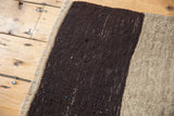 Hand woven texture of vintage Turkish Kilim with charcoal and antique ivory stripes.