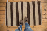 Vintage Turkish Kilim rug with alternating chocolate brown and ivory vertical stripes.