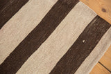 Textured weave of the vintage Turkish Kilim with chocolate brown and ivory bands.