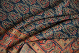 Orange brick red border with navy and beige stylized motifs on the vintage Malayer rug.