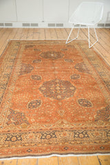 Ivory fringe and detailed border with coffee brown and ivory florals on the distressed Kaisery rug.