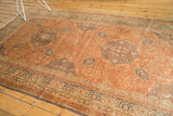 Distressed vintage Turkish Kaisery carpet with muted dusty rose and grey floral motifs.