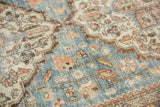 Distressed blue and terracotta floral vinery on a vintage Persian Mahal carpet.